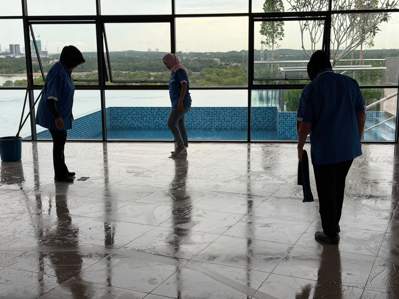 CSC Services team cleaning a poolside hall